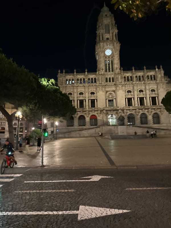 Evening activity captured around illuminated Porto City Hall