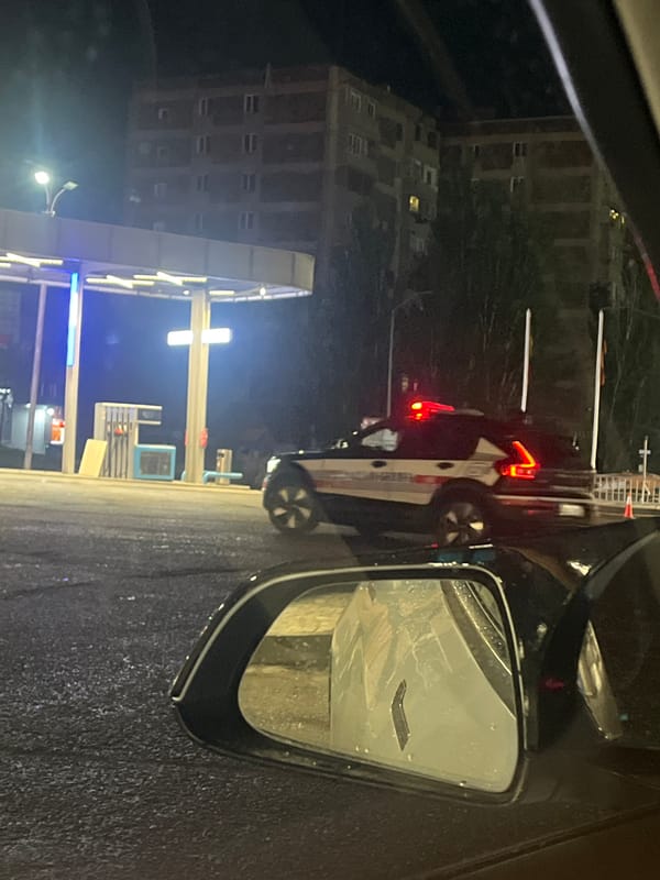 Nighttime vehicle scene documented on wet Yerevan street