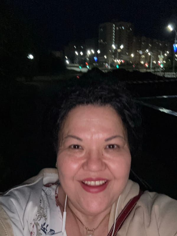 Woman captures nighttime selfies in urban setting