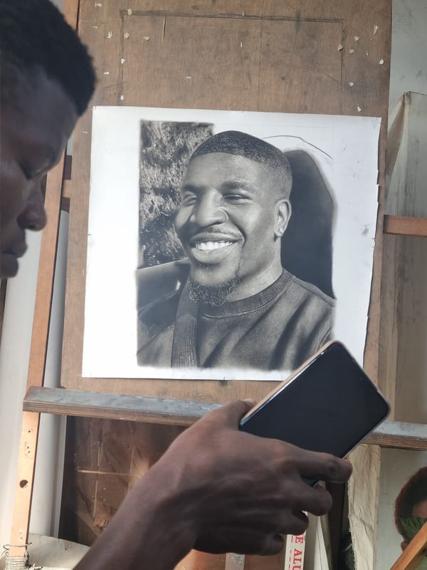 Street artist creates charcoal portraits in Onitsha, Nigeria
