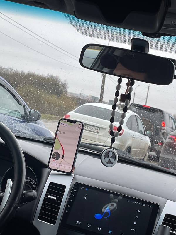 Driver's dashboard view with mounted smartphone map in Russia