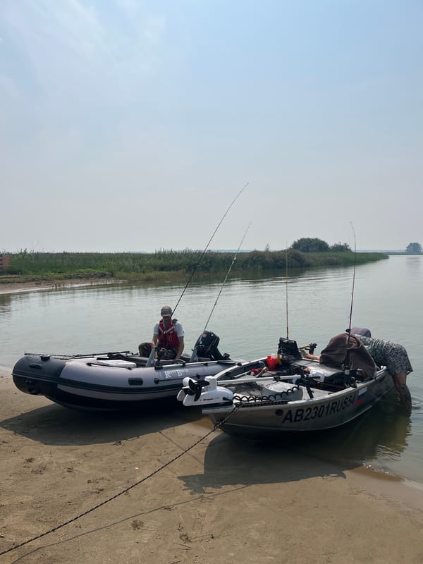 Fishing boats on the Ob River near Novopichugovo on a hazy morning