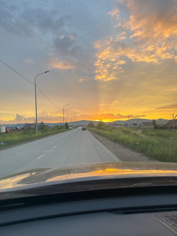 Rural road trip wraps up under a golden sunset sky