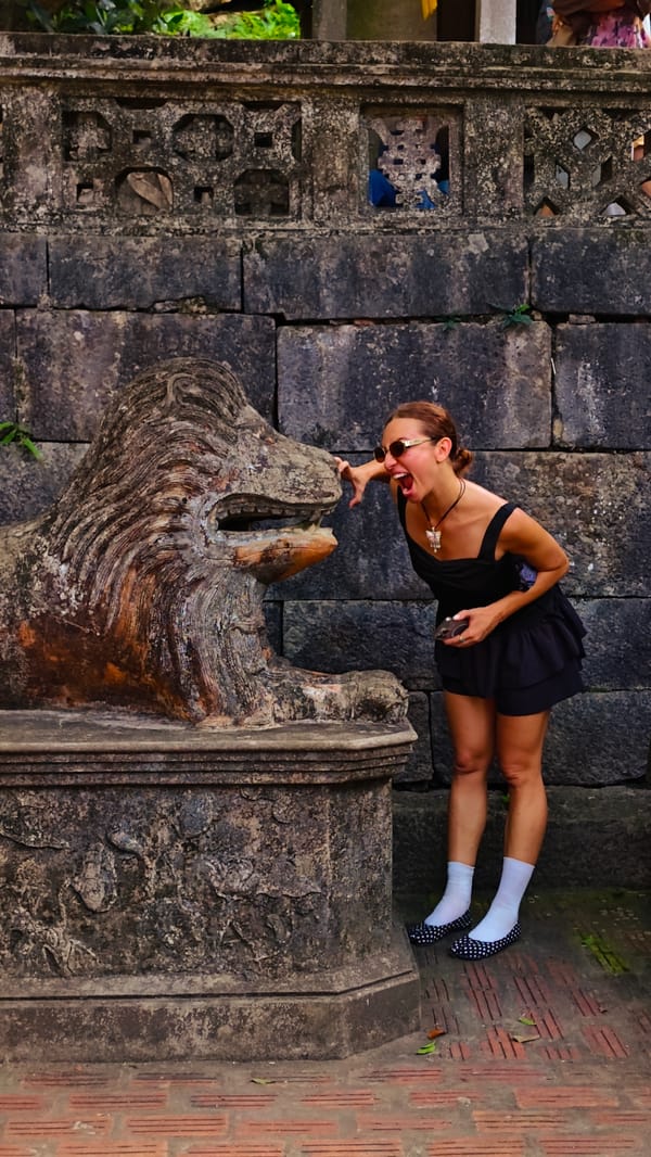 Morning tourists explore Vietnamese temple complex in karst landscape