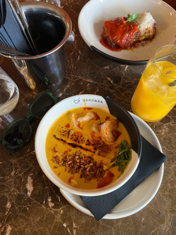 Person relaxes barefoot on balcony railing in Montenegro