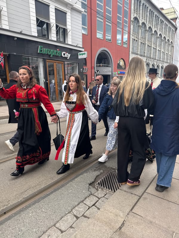 Women in traditional bunad costumes gather in Oslo streets