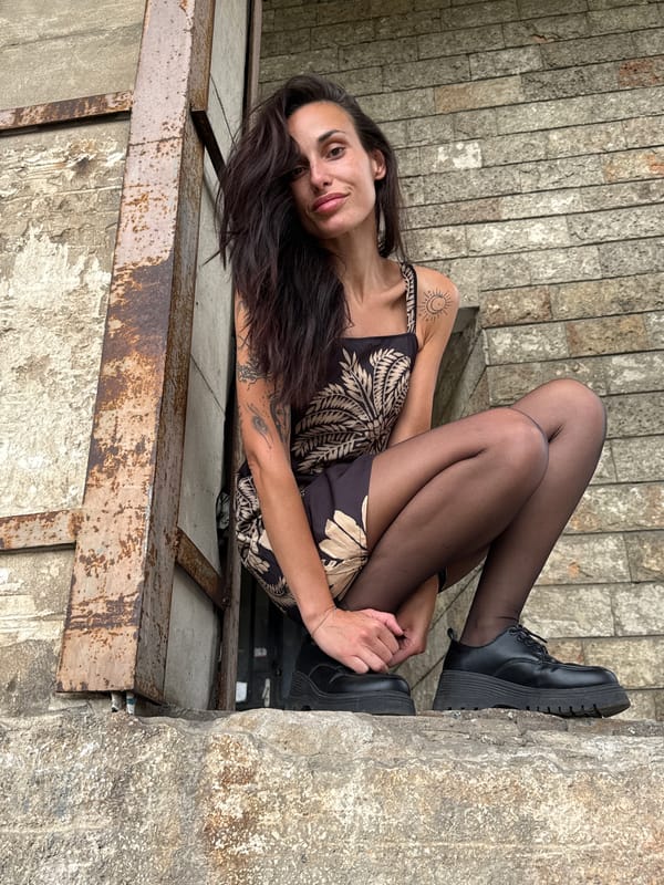 Woman poses for photos on metal guardrail in Pleven