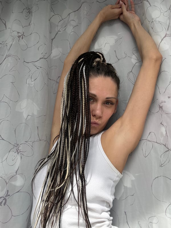 Woman with braided hair poses with tulips at Russian playground