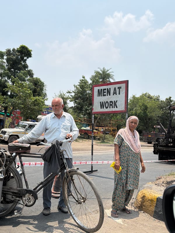 Two people outdoors on a sunny day in Ahmadpur, India.