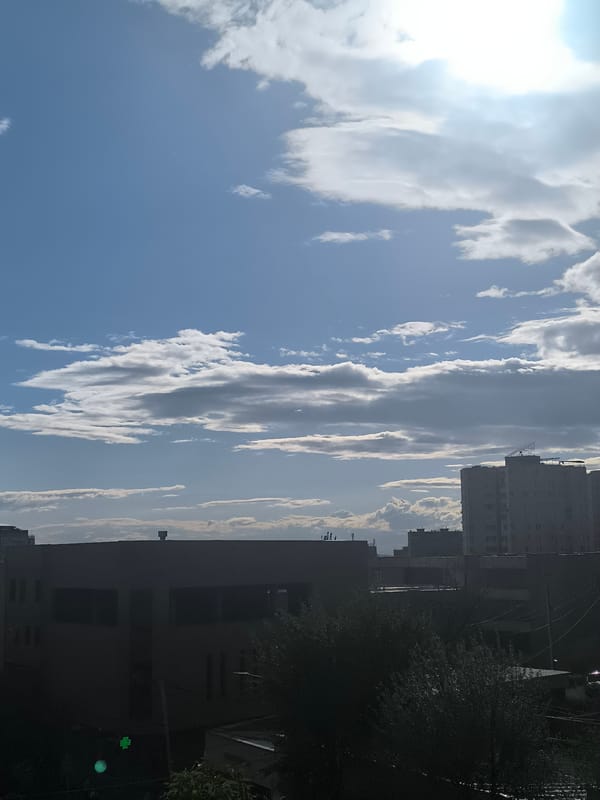 Urban sky and masked worker documented in separate locations