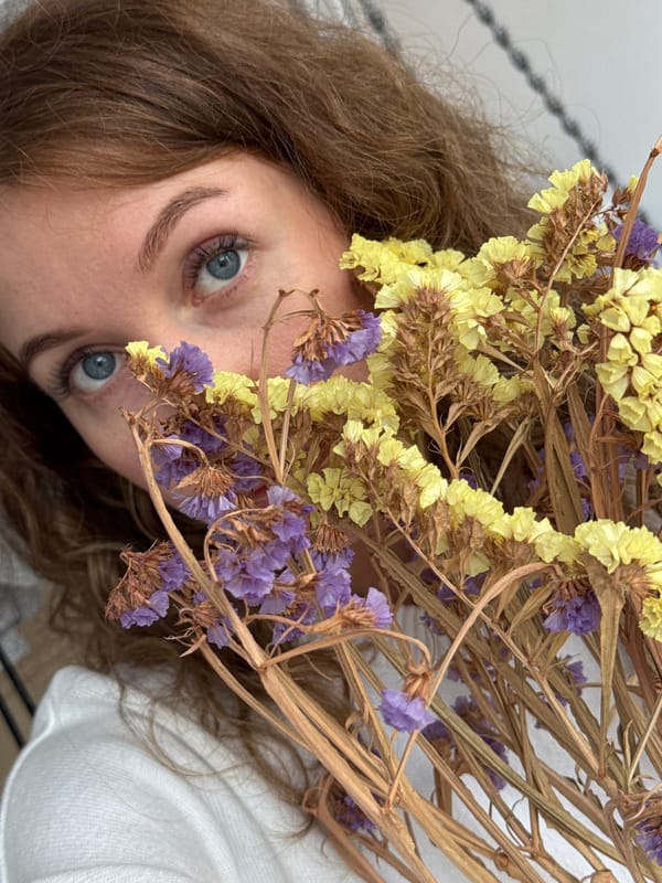 Woman arranges dried flower bouquet in Chaikovsky, Russia