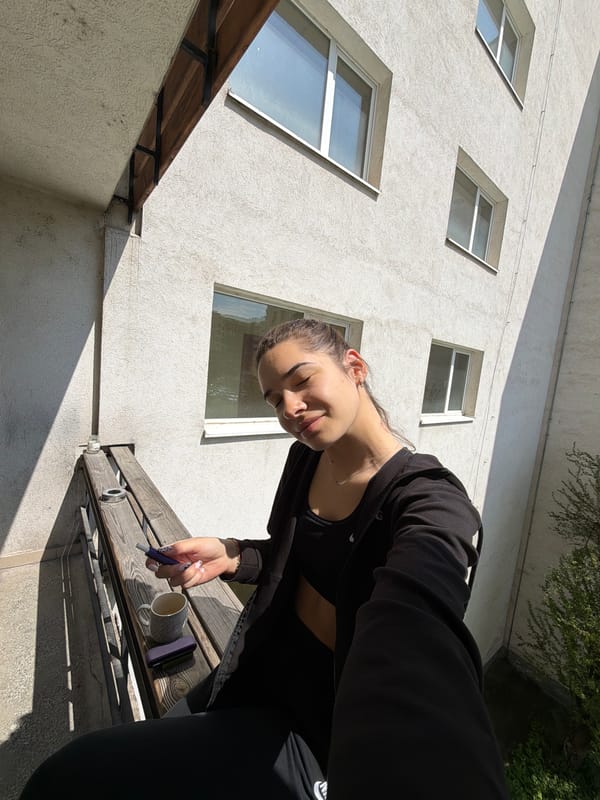 Woman writes with coffee on Sofia balcony morning