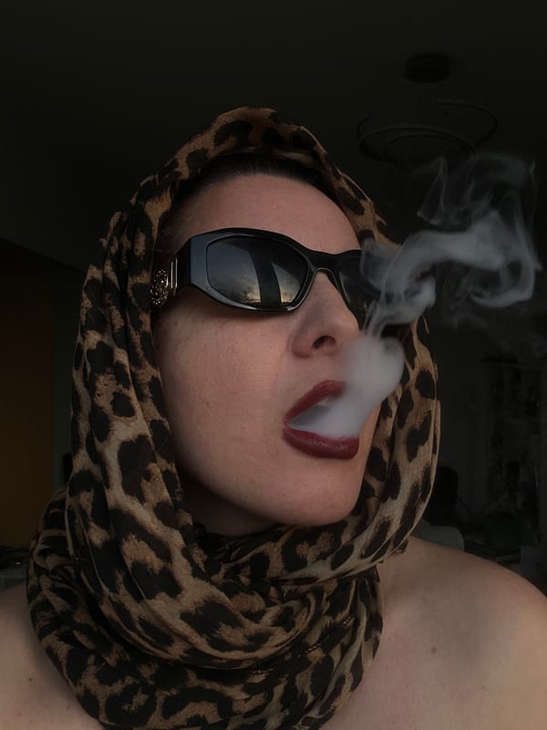 Person in leopard scarf vapes indoors in Riga