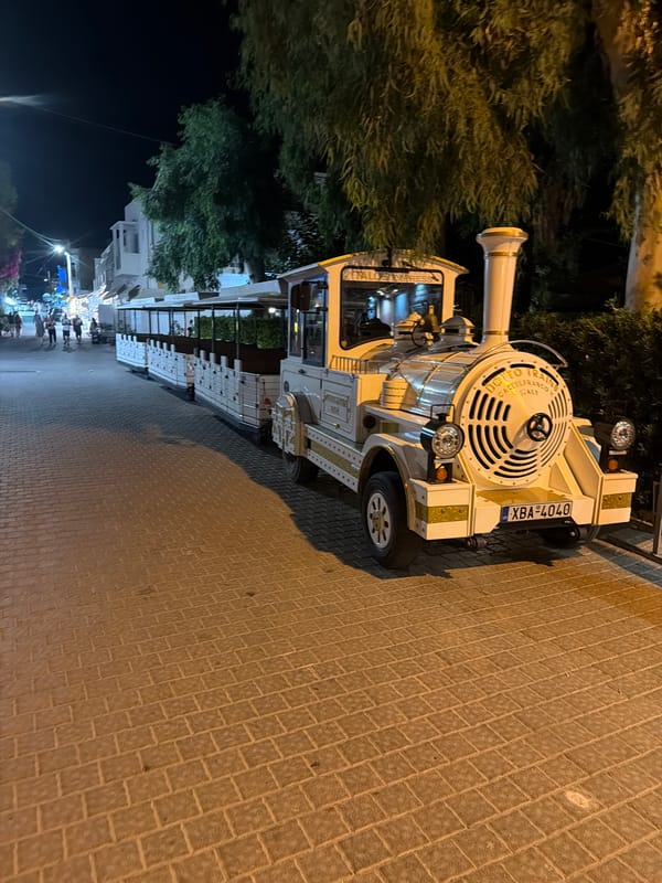 Tourist train parked on cobblestone streets in Georgioupoli at night