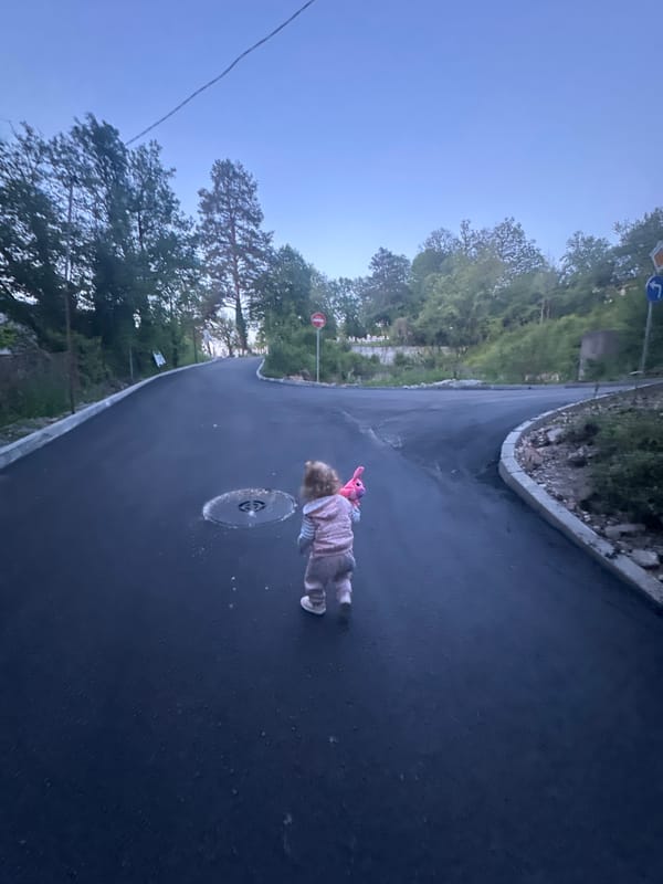 Toddler in pink plays around Tryavna streets and stairs