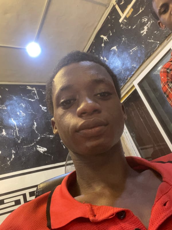 Young man takes selfies at Onitsha barbershop