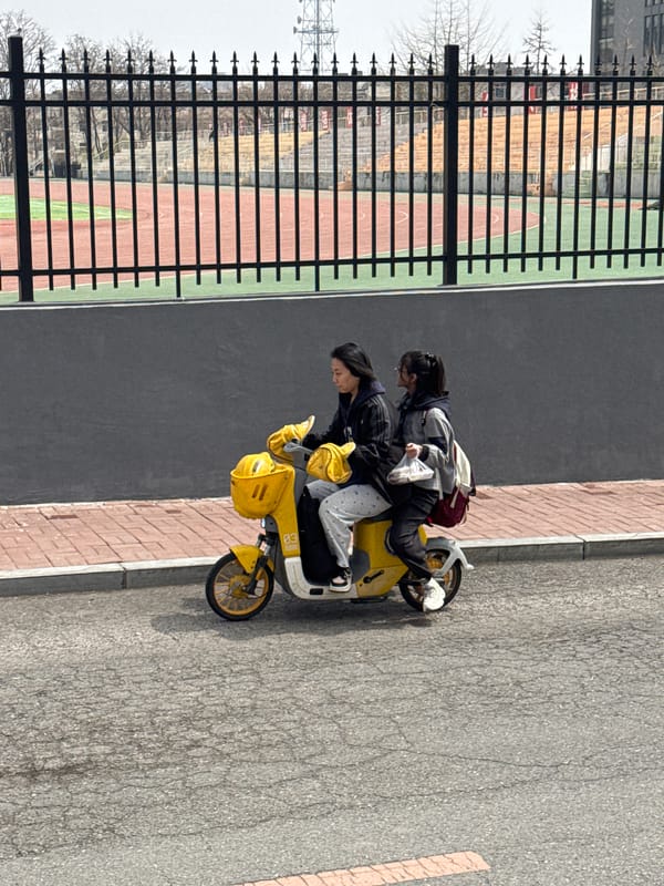 Young people gather with yellow electric scooter in Zhongtun