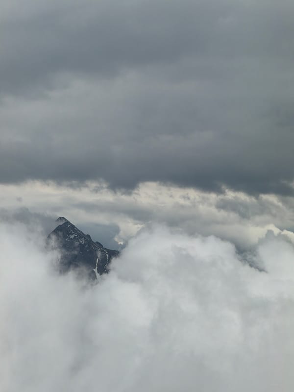 Mountain peak shrouded in dense clouds observed