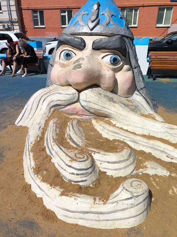 Urban park features artistic sculptures and castle playground entrance