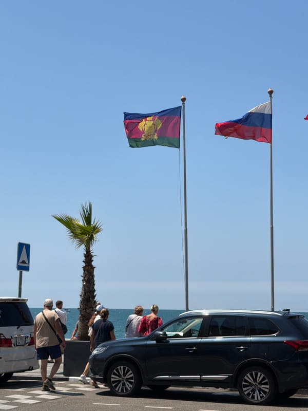 Summer morning beach crowds along Sochi's Black Sea promenade