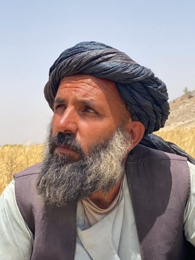Man in traditional dress observed in Afghan field