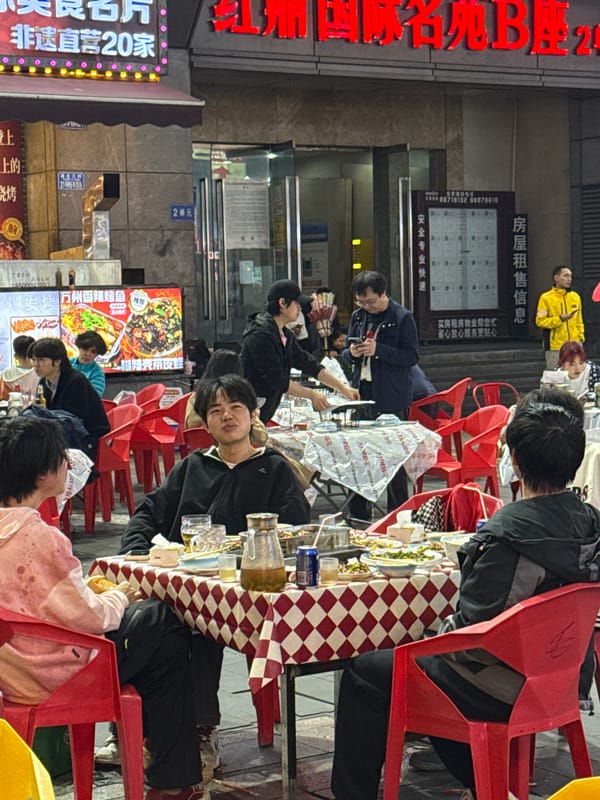 Nighttime street food dining scene bustles in Liangjiang commercial district
