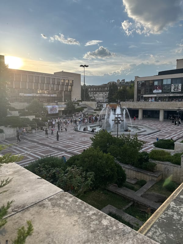Public square bustling with activity during golden hour
