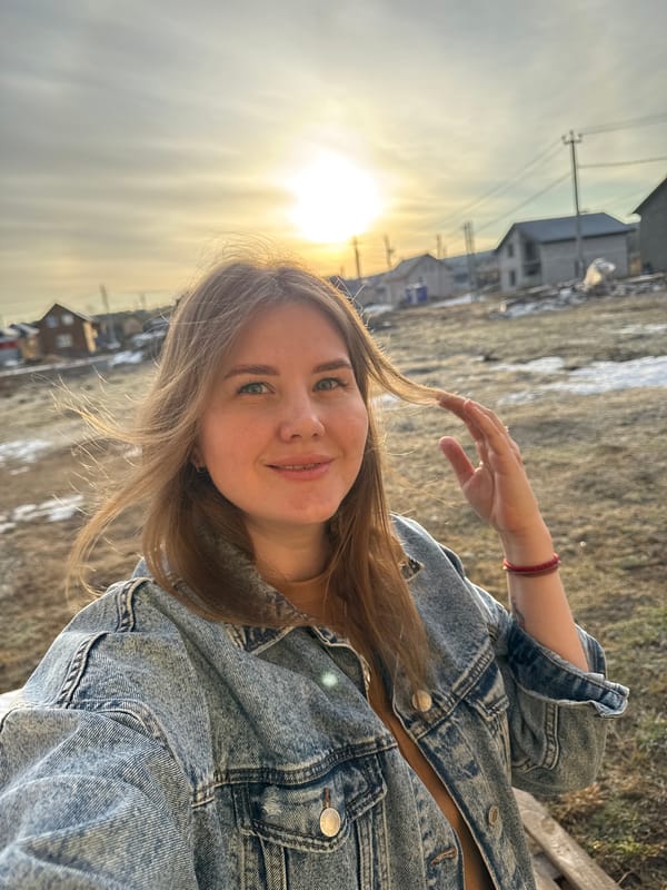 Woman takes sunny selfies on bench in Russian town