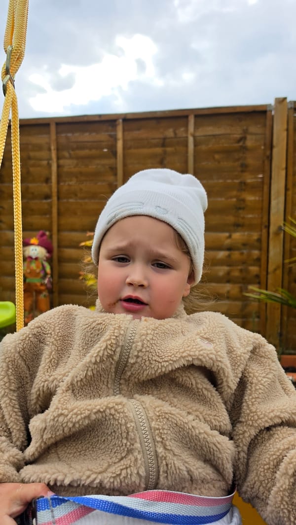 Toddler spotted in London wearing winter clothing and harness