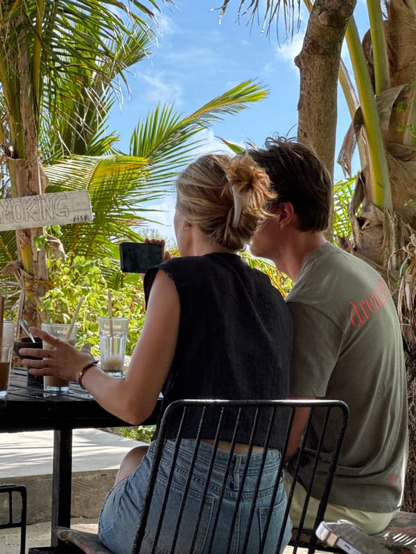 Two people dining outdoors in General Luna, Philippines
