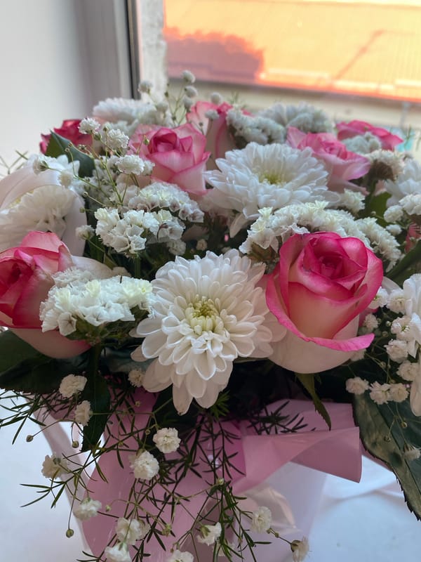 Fresh flower arrangements and a portrait, July 2026