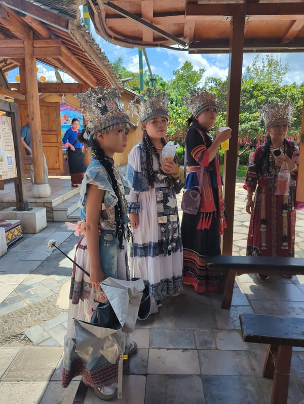 Ethnic cultural site in Xishan District, swords, craft displays, and a corgi