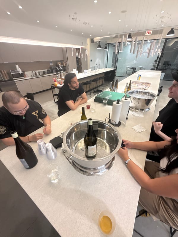 Four people gather in bright modern kitchen space