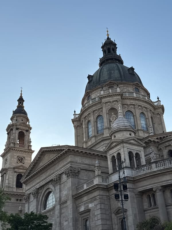 Tourist photographs St. Stephen's Basilica from multiple angles in Budapest