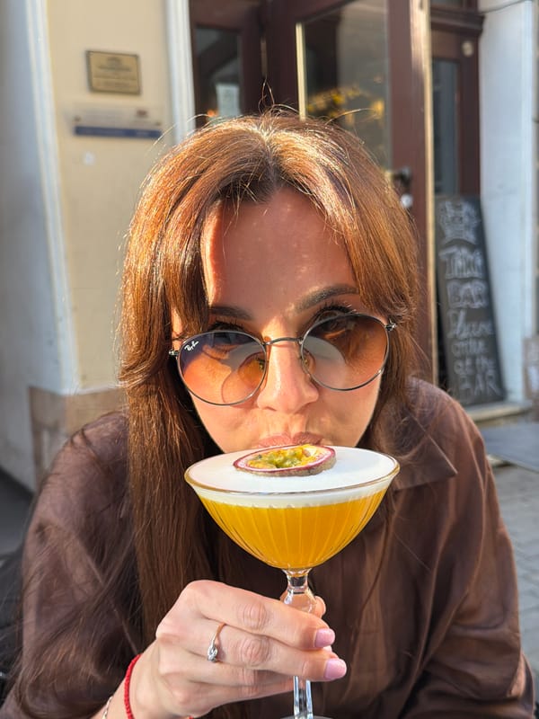 Woman enjoys cocktails outdoors in sunny Riga afternoon