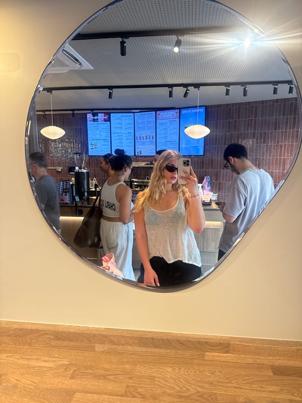 Customer takes selfie with juice drink at Paris café