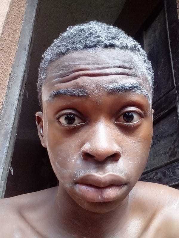 Man applies white cream while grooming in Onitsha home