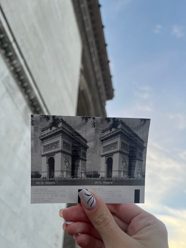 Person displays Arc de Triomphe tickets in Paris