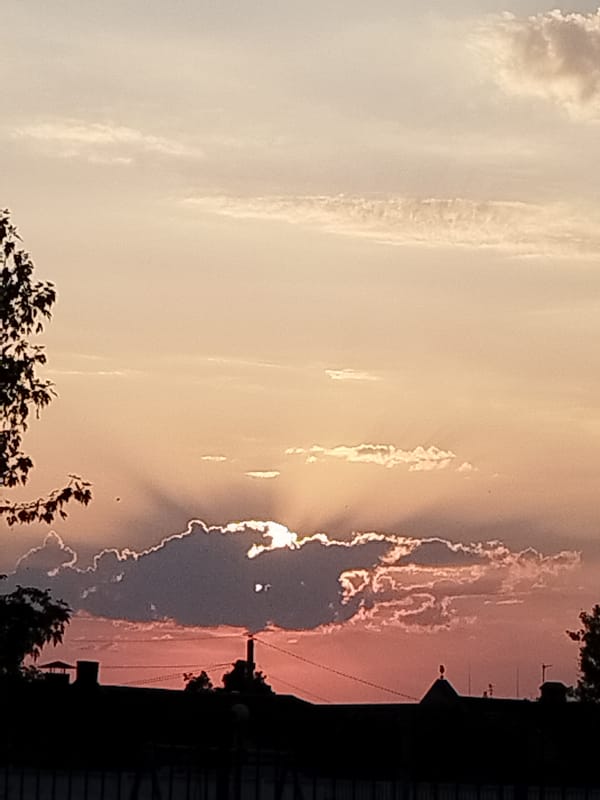 Crepuscular rays and soft color at sunset over Brest