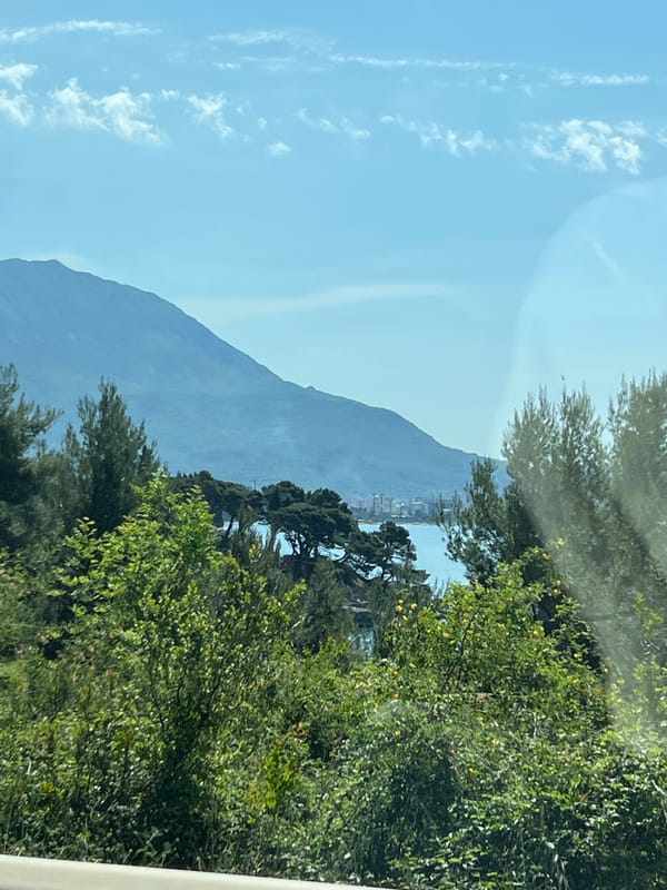 Coastal mountain view photographed through window in Sutomore