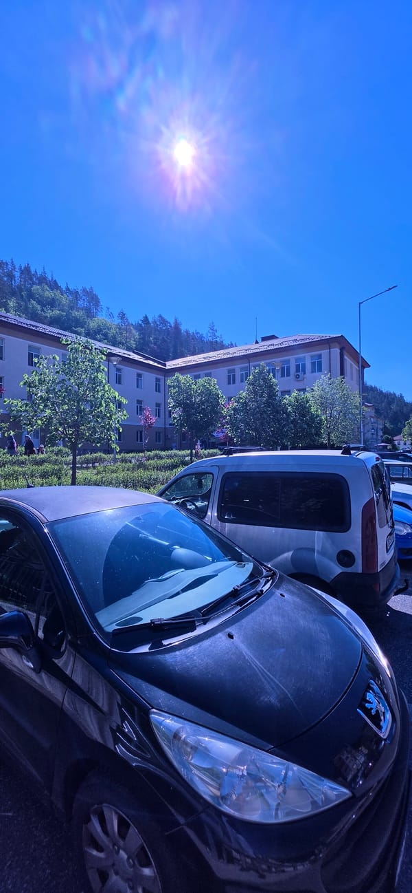 Morning scenes documented in Madan, Bulgaria including buildings and vehicles