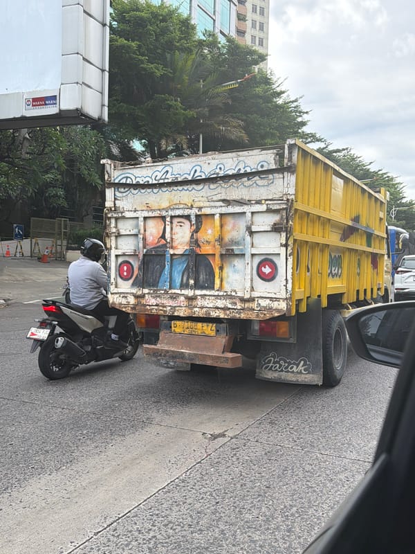 Painted truck spotted with motorcyclist in West Jakarta morning traffic