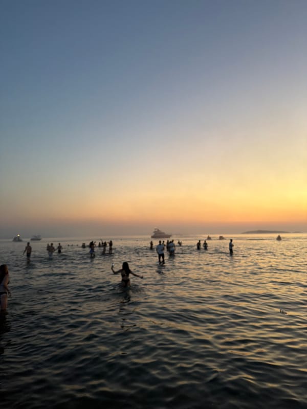 Sunset crowd wading in the shallows at Sozopol's waterfront