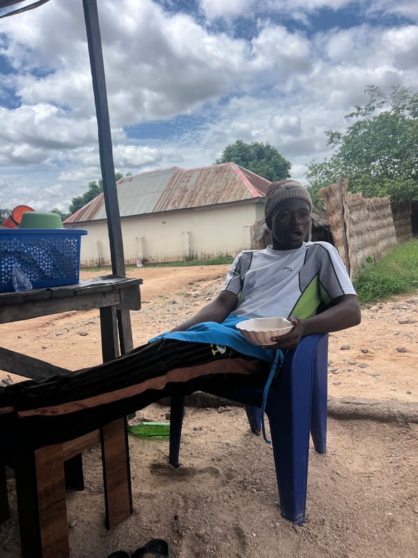Young man rests under shelter in Howayi, Nigeria