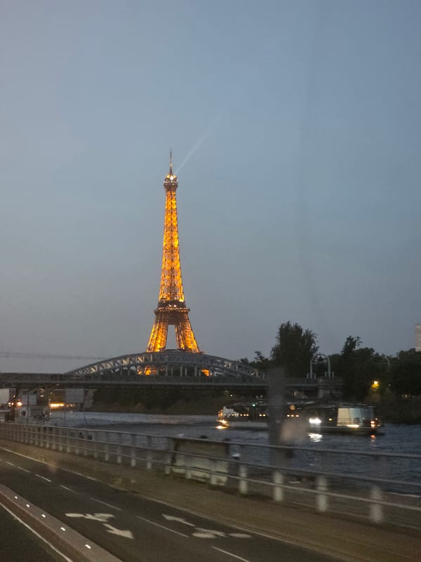Eiffel Tower glowing gold at dusk, Paris