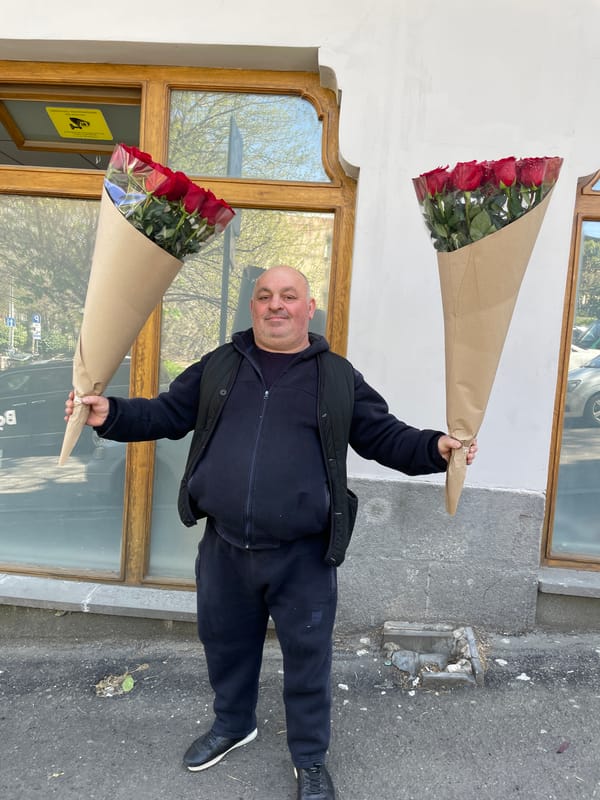 Man with roses, tea service observed in Tbilisi