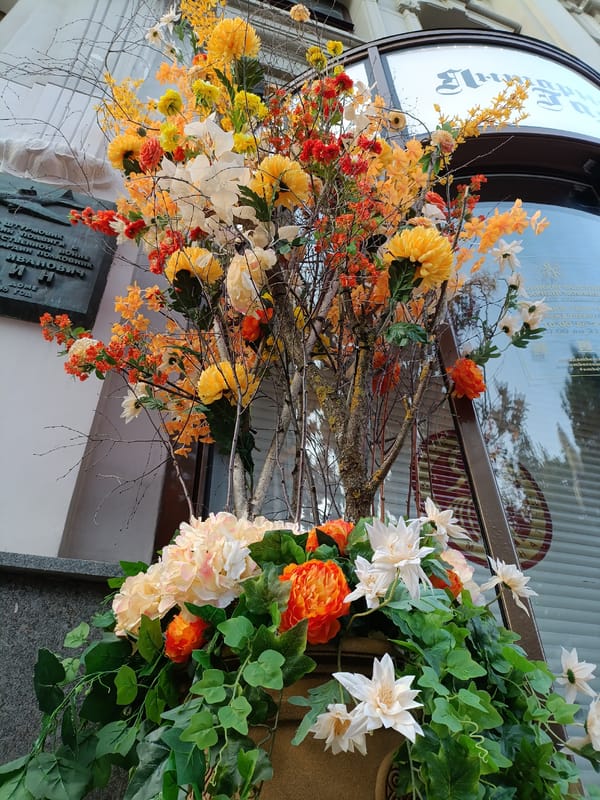 Colorful artificial flower display in Moscow planter