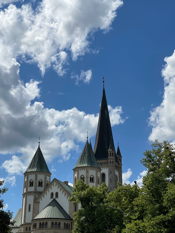 Tourist documents historic churches across Wrocław during midday photography walk