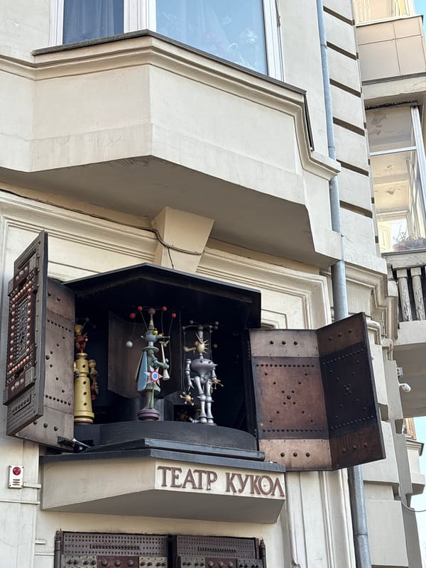 Pedestrians cross street near Krasnoyarsk Puppet Theatre