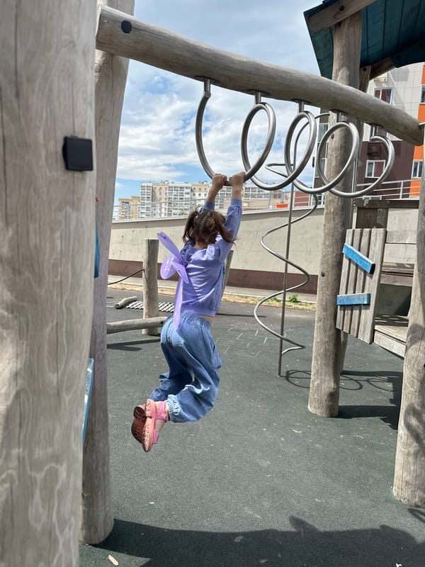Child plays on climbing structure at Khabarovsk playground